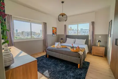 a bedroom with a bed and two windows at Perfect for families, Beach 3 Min away, Brand New in Limassol