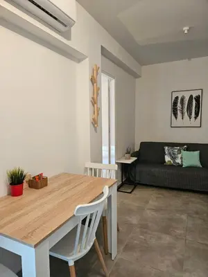 a living room with a table and a couch at SC_apartments in Kato Pyrgos