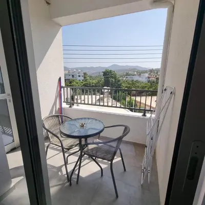a balcony with a table and chairs and a view at SC_apartments in Kato Pyrgos