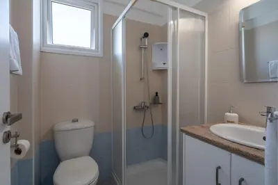 a bathroom with a shower and a toilet and a sink at Chloris 3- Bedroom Apartment W/Pool in Larnaca in Larnaka