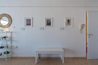 a white room with a table and a mirror at Chloris 3- Bedroom Apartment W/Pool in Larnaca in Larnaka