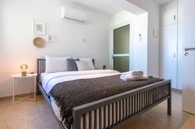 a bedroom with a large bed in a room at Chloris 3- Bedroom Apartment W/Pool in Larnaca in Larnaka