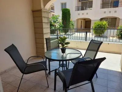 a patio with a table and chairs on a balcony at Pyla Palms Resort B1 - 1 in Larnaka