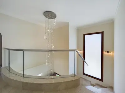 a glass staircase with a water fountain at Fabulous beach front house with pool in Larnaka