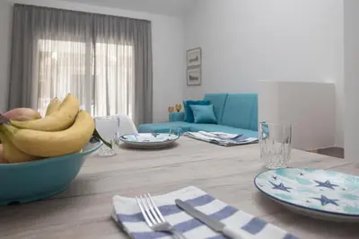 a table with a bowl of bananas on top of it at Lovely Studio by the Beach in Voroklini