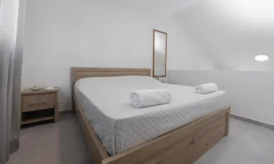 a bedroom with a bed with two towels on it at Lovely Studio by the Beach in Voroklini