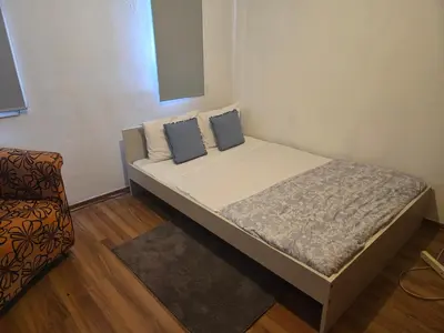 a small bed in a room with a chair at Tereza's House in Ayvaryara