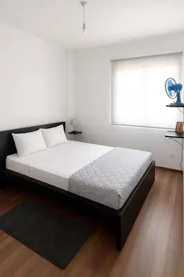 a bed in a bedroom with a window at Tereza's House in Ayvaryara