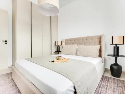 a bedroom with a large white bed with a tray on it at Sanders Premier Downtown in Limassol