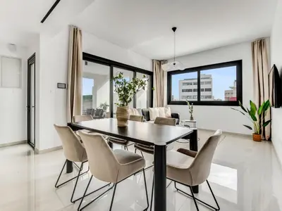 a dining room with a table and chairs at Sanders Premier Downtown in Limassol