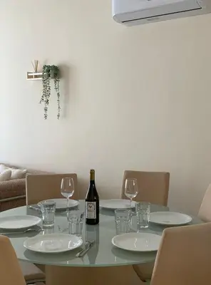 a table with glasses and a bottle of wine on it at Quiet kykladesAG10/near the beach, Paralimni in Paralimni