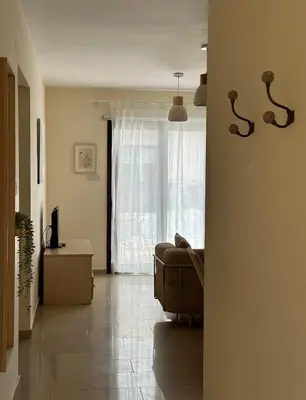 a living room with a couch and a window at Quiet kykladesAG10/near the beach, Paralimni in Paralimni