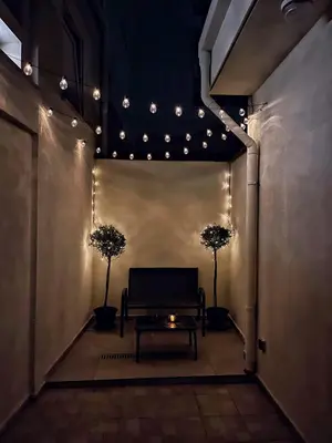 a hallway with a bench and a table with lights at Cozy house city center in Limassol in Limassol