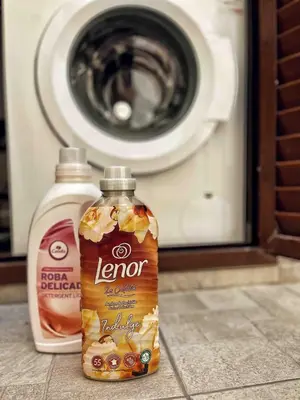 two bottles of cleaner sitting next to a washing machine at Cozy house city center in Limassol in Limassol