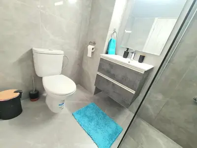 a bathroom with a toilet and a sink and a shower at Beach Serenity Studio on Makenzy in Larnaka