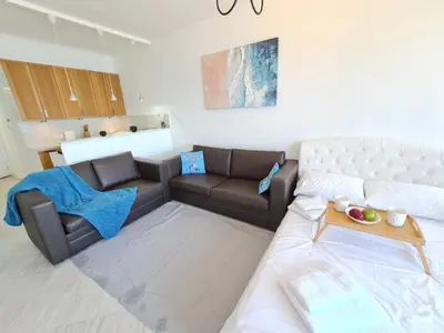 a living room with a couch and a table at Beach Serenity Studio on Makenzy in Larnaka