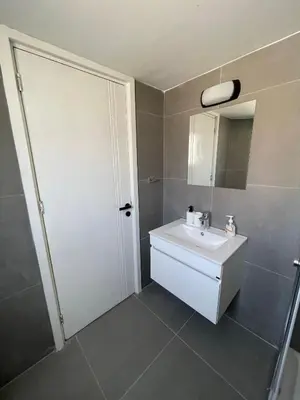 a bathroom with a white sink and a mirror at Nicosia Downtown Cozy in Nicosia
