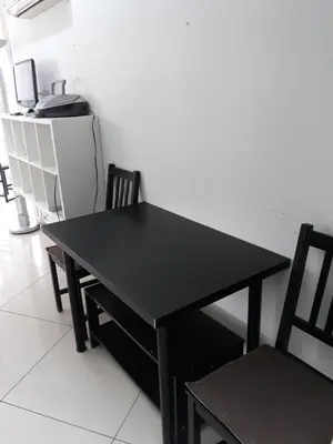 a black table and two chairs in a room at A MODERN APARTMENT FOR YOU in Nicosia