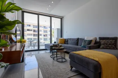 a living room with a couch and a table at Flair - 1-Bedroom Apartment & Balcony in Larnaca in Larnaka