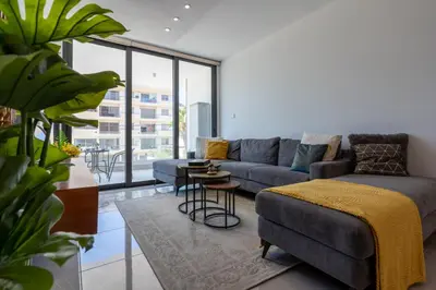 a living room with a couch and a table at Flair - 1-Bedroom Apartment & Balcony in Larnaca in Larnaka