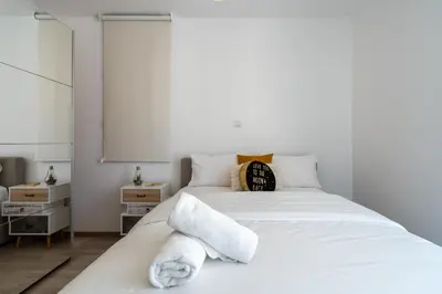 a bedroom with a white bed with towels on it at Flair - 1-Bedroom Apartment & Balcony in Larnaca in Larnaka
