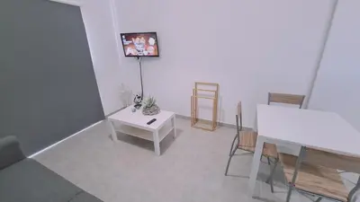 a living room with a white table and a desk at STAY Sand Flat in Paralimni