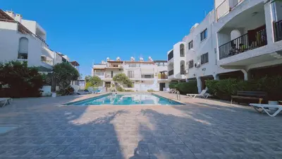 a swimming pool in a courtyard of a building at STAY Sand Flat in Paralimni
