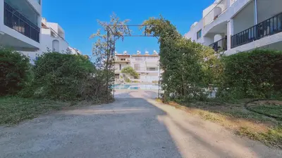 an entrance to a building with an ivy covered gate at STAY Sand Flat in Paralimni