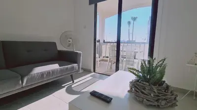 a living room with a couch and a table with a plant at STAY Sand Flat in Paralimni