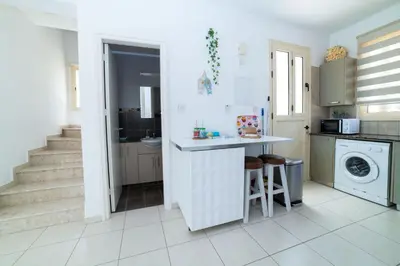a kitchen with a sink and a washing machine at Villa Anna Maria, Kapparis in Paralimni