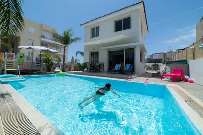 a woman in a swimming pool in a house at Villa Anna Maria, Kapparis in Paralimni