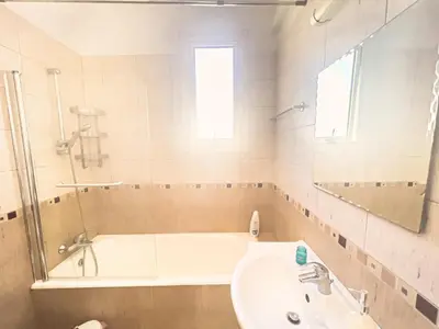 a bathroom with a bath tub and a sink and a bath tubermott at Villa Anna Maria, Kapparis in Paralimni