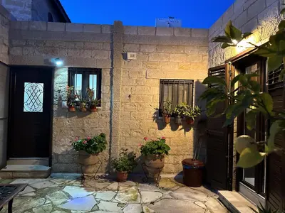 a house with potted plants on the side of it at Cosy Piano village cottage in Pachna in Pachna
