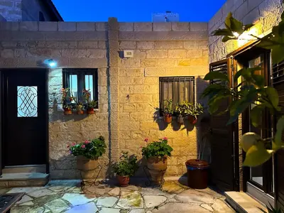 a house with potted plants on the side of it at Cosy Piano village cottage in Pachna in Pachna
