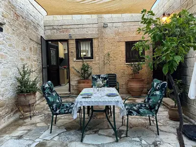 a table and four chairs on a patio at Cosy Piano village cottage in Pachna in Pachna
