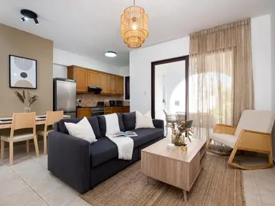 a living room with a blue couch and a table at Cute & Cozy Mazotos 1bed Getaway in Mazotos