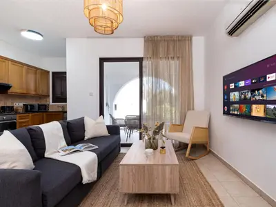 a living room with a couch and a table at Cute & Cozy Mazotos 1bed Getaway in Mazotos