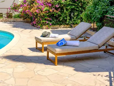 two lounge chairs next to a swimming pool at Cute & Cozy Mazotos 1bed Getaway in Mazotos