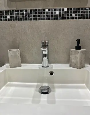 a white sink with a faucet on top of it at Charming House in the Heart of Limassol in Limassol