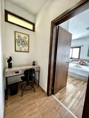 a room with a desk and a bedroom with a bed at Charming House in the Heart of Limassol in Limassol