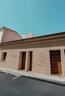 a building with four doors on the side of it at Charming House in the Heart of Limassol in Limassol