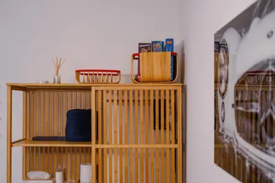 a wooden shelf with items on it next to a wall at Fat Cow Apartments in Larnaka