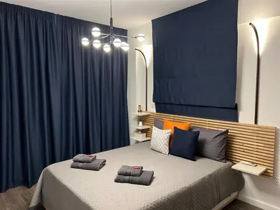 a bedroom with a bed with two pillows on it at Fat Cow Apartments in Larnaka