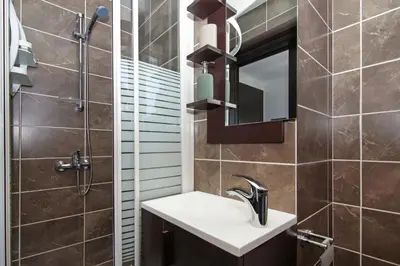 a bathroom with a sink and a mirror at Villa Michaella - 500m from Golden Beach in Paralimni