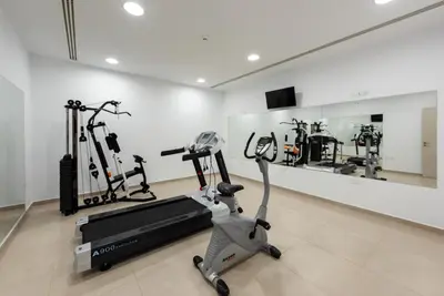 a gym with two tread machines and a treadmill at Seafront Villa Layla by Ruidoso Luxury in Ayia Napa