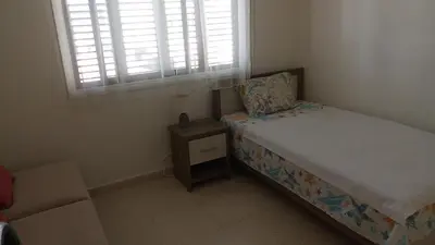 a small bedroom with a bed and a window at 2 bedroom apartment in Makenzi in Larnaka