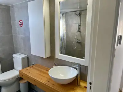 a bathroom with a sink and a toilet at Seaview Beach Apartment Dasoudi in Limassol