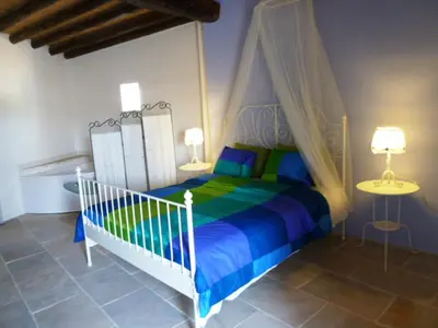 a bedroom with a bed with a canopy at To Archontiko tis Anastasias in Athienou