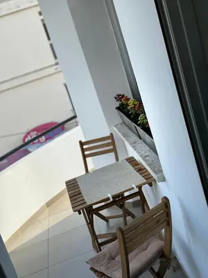 two chairs and a table in a room with a window at Anastasia 1 Bedroom Apartment in Limassol