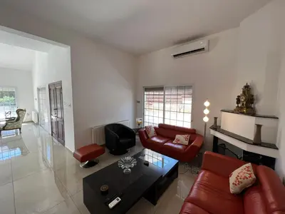 a living room with a couch and a table at Villa Sawa by Ezoria Villas in Limassol